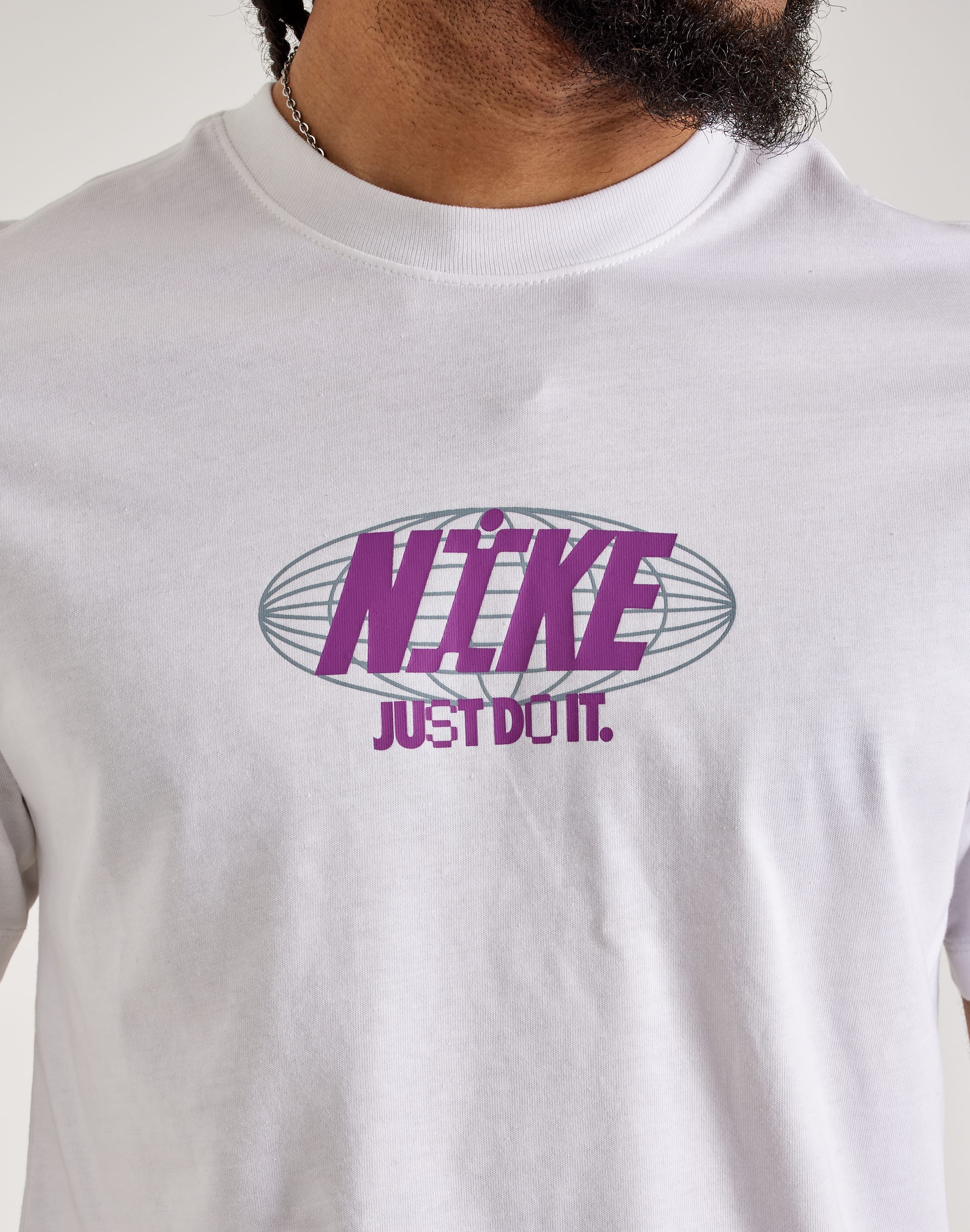white nike shirt with purple logo